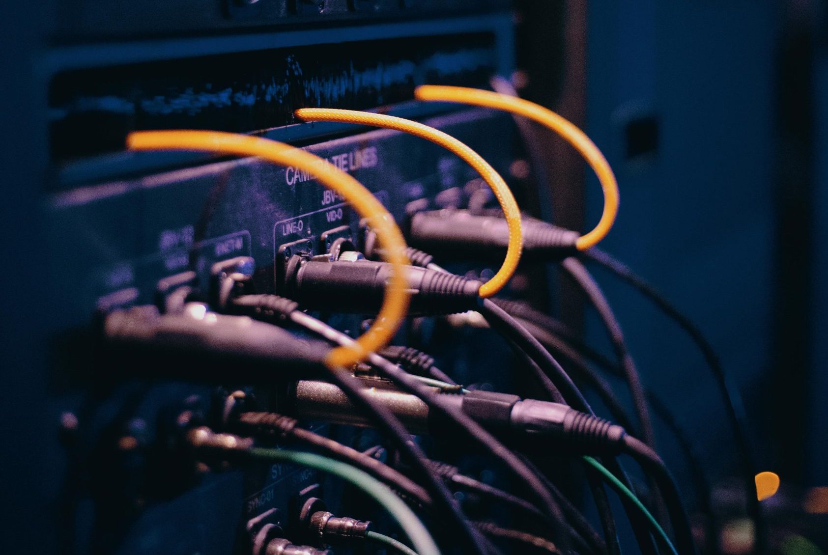 Close-up of network cables and ports in a server rack, showcasing connectivity.